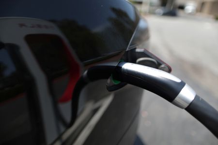Exclusive-To tap U.S. government billions, Tesla must unlock EV chargers