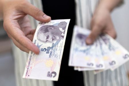Turkey’s lira hits record low but rebounds after quake, stocks slip